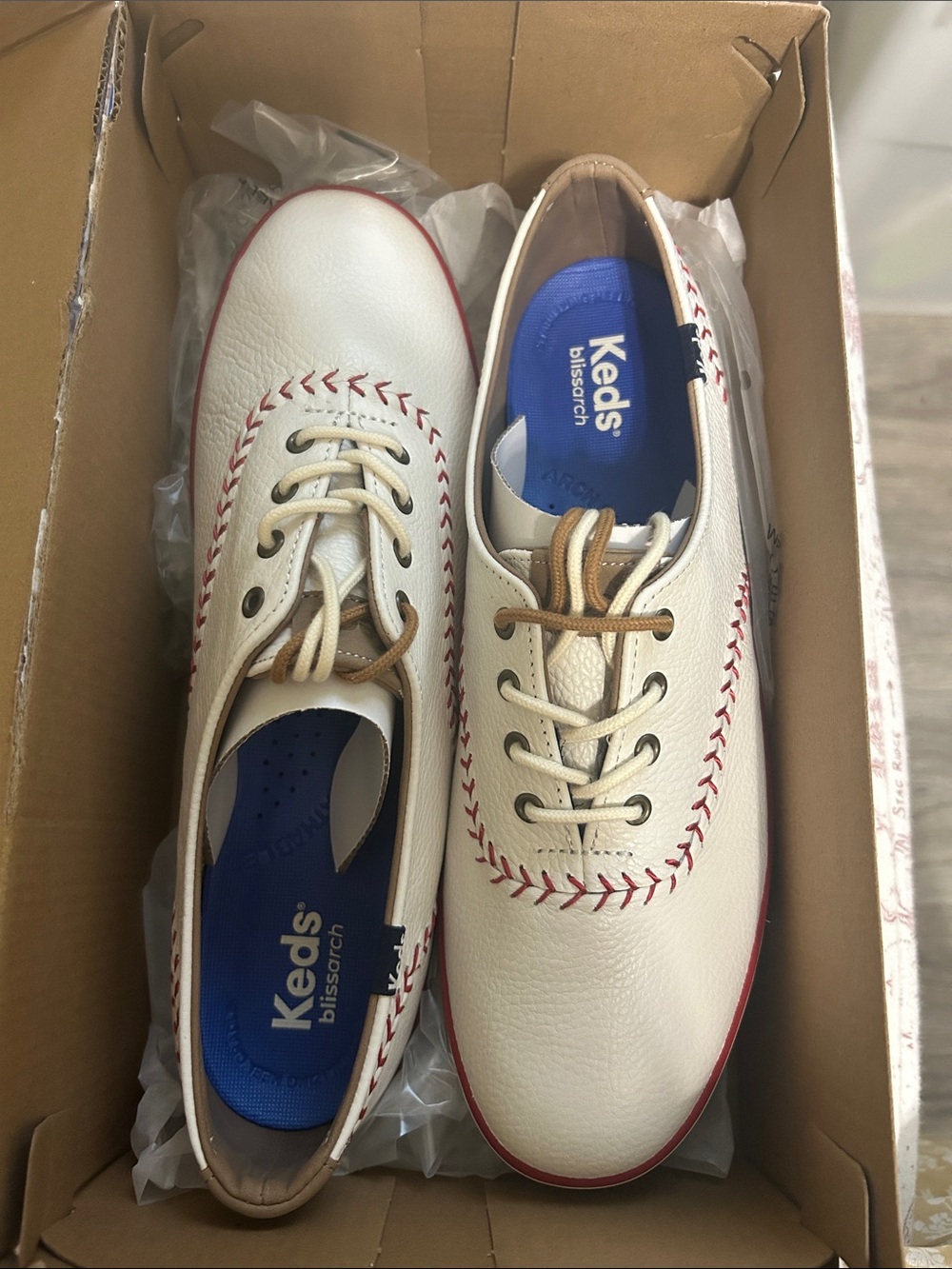 Keds Cream Leather Sneakers with Red Stitch Accents